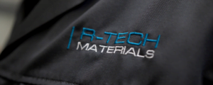 R-TECH Materials logo on uniform